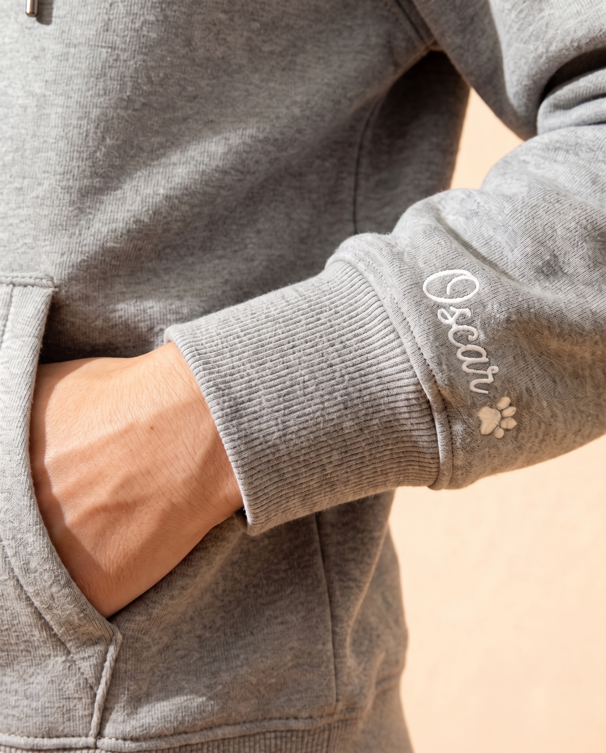 Pet name embroidered in script on the hoodie sleeve