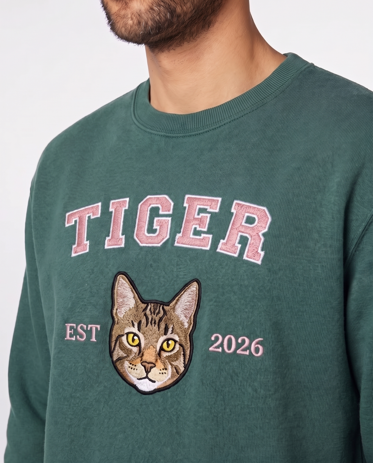 Green University sweatshirt with an embroidered tabby cat portrait