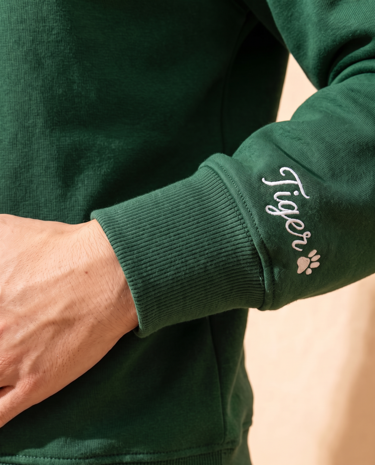 Pet name embroidered in script on the sweatshirt sleeve