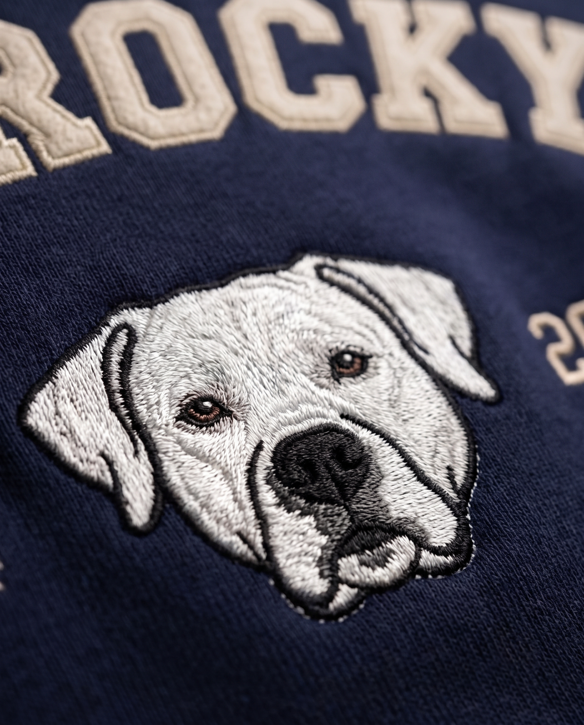 Close-up of the embroidered labrador portrait and collegiate lettering